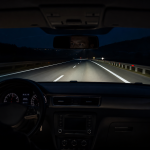Car night vision display detecting a pedestrian on a dark road during a long trip