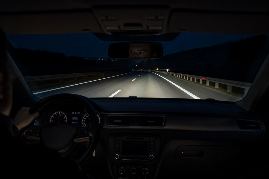 Car night vision display detecting a pedestrian on a dark road during a long trip