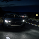 Car driving on a dark highway during a nighttime road trip