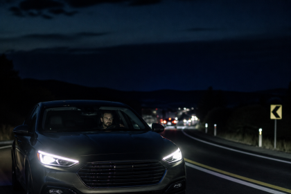 Car driving on a dark highway during a nighttime road trip