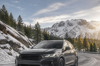 Car driving on a snowy road where all-wheel drive may improve traction