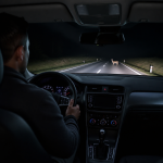 Thermal night vision camera display detecting a pedestrian and vehicle on a dark road